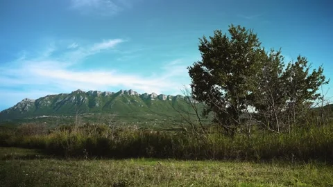 Mountain landscape with blue sky, clouds, fields and trees in Cilento Video stock 255728544