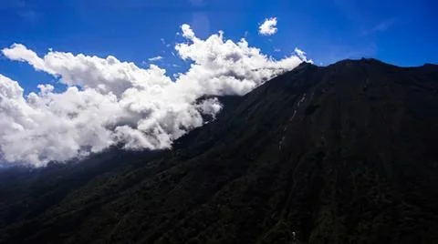 Mountain landscape with clouds and blue sky above Stock Photos