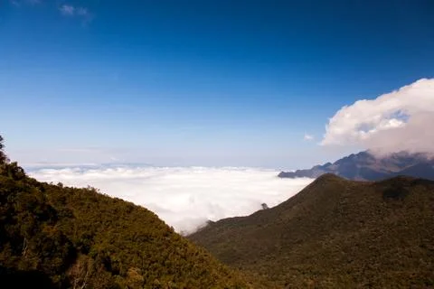 Mountain landscape with clouds below Stock Photos