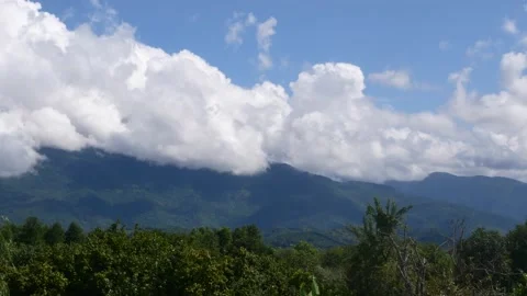 Mountain landscape - clouds over a mountain covered with green forest. Stock Footage 167352315