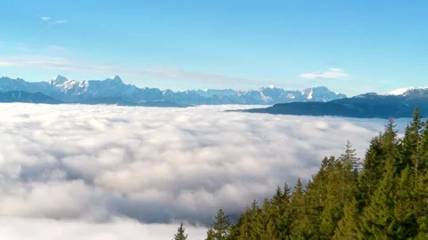 Mountain landscape, colors changing from blue to white, thick fog covering Stock Footage 256237995