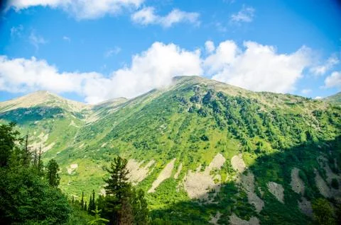 Mountain landscape. deciduous forest. cloud on top. morning light Stock Photos