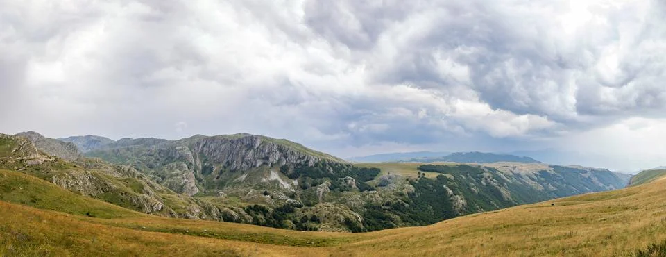 Mountain landscape with dramatic stormy clouds in sky Stock Photos