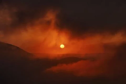 Mountain landscape with dramatic sunset in clouds background Stock Photos