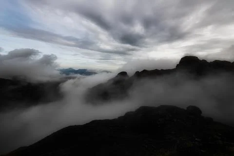 Mountain landscape in the evening with the play of clouds between the peaks Stock Photos
