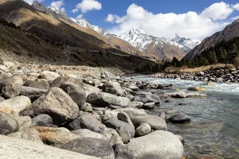 Mountain landscape featuring a clear river flowing through rocky terrain wi.. Stock Photos
