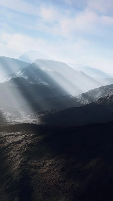 Mountain landscape with light rays shining down on the terrain in the morning Stock Footage 338419150