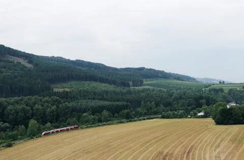 Mountain landscape with red train Stock Photos