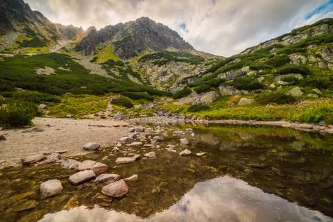 Mountain Landscape with Reflection on the Surface of a Tarn Stock Photos