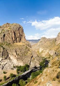 Mountain landscape with a river that flows through the gorge. Stock Photos