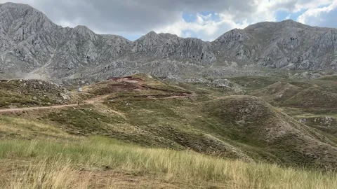Mountain Landscape with Sheep Herd and Shepherd in Alpine Pasture Stock Footage 343830907