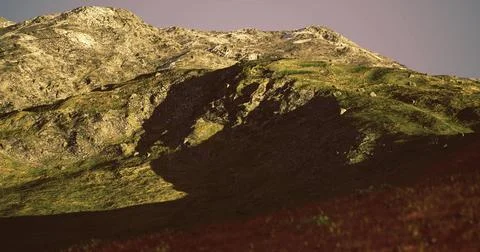 Mountain landscape showcasing dramatic shadows under soft sunlight 스톡 일러스트