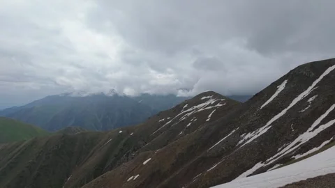 Mountain landscape with snow-capped peaks and cloudy sky in Central Asia Stock Footage 336965002
