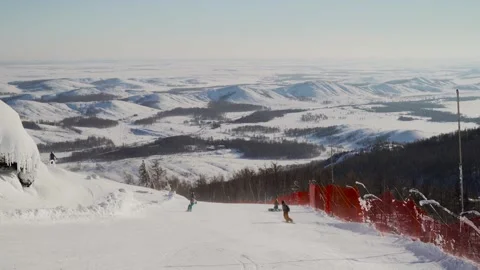 Mountain landscape: snowboarders roll down the slope. Stock Footage 256155983