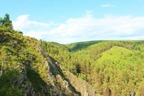 Mountain landscape through the foliage of trees. Breathtaking panoramic view Stock Photos