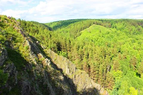 Mountain landscape through the foliage of trees. Breathtaking panoramic view Stock Photos
