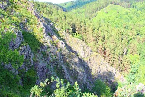 Mountain landscape through the foliage of trees. Breathtaking panoramic view Stock Photos