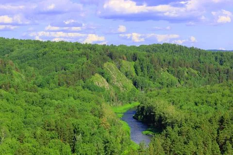 Mountain landscape through the foliage of trees. Breathtaking panoramic view Stock Photos