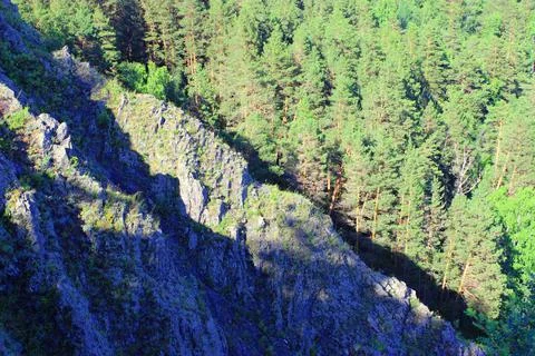 Mountain landscape through the foliage of trees. Breathtaking panoramic view Stock Photos