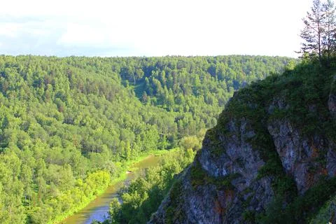 Mountain landscape through the foliage of trees. Breathtaking panoramic view Stock Photos