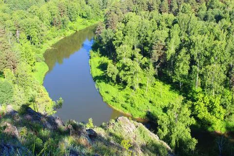 Mountain landscape through the foliage of trees. Breathtaking panoramic view Stock Photos
