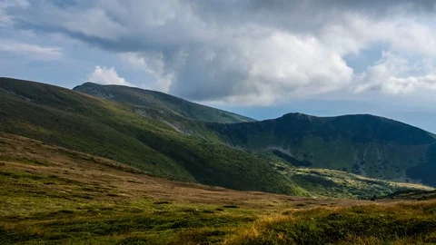 Mountain landscape timelapse footage. Moving clouds over green summer mountai Stock Footage 115703853