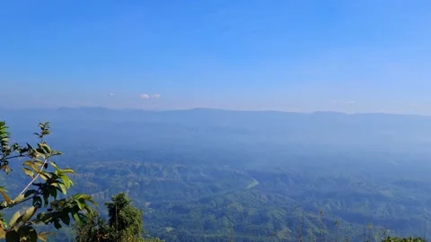 Mountain landscape with tree in foreground and blue sky Stock Footage 330467588