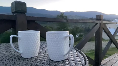 Mountain landscape, two white cups of tea and evening relaxation in nature Stock Footage 255274507
