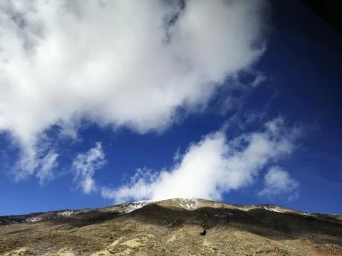 Mountain landscape under dramatic blue sky with clouds Stock Photos