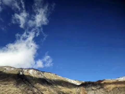 Mountain landscape under dramatic blue sky with clouds Stock Photos