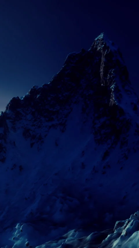 Mountain landscape under moonlight with snow and rocky peaks in evening Stock Footage 339779489