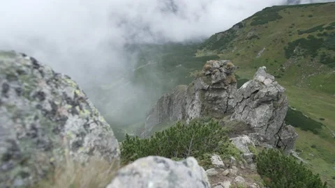 Mountain landscape with white clouds and mystical rocks Stock Footage 231684332