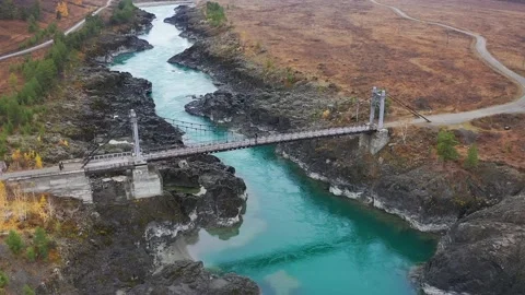 Mountain landscapes overlooking a mountain river with bridge Stock Footage 220034720