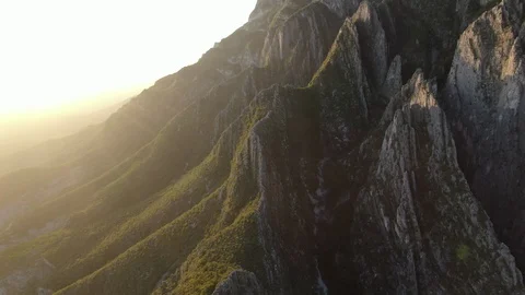 Mountain with Large Rock Face During Sunrise Stock Footage 128537680