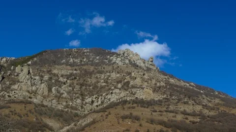 Mountain with a ledge of a rock resembling a human face Stock Footage 123583661