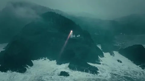 Mountain Lighthouse Beam Sweeping Over Choppy Sea at Dusk Stock Footage 315099137