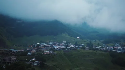 Mountain low clouds time lapse in evening above Georgian mountain village in Stock-Footage 247436911