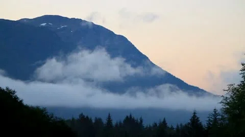 Mountain with low level clouds flowing past Stock Footage 10747332