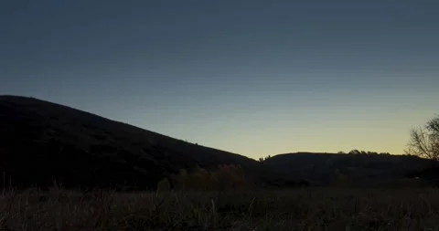 Mountain meadow time-lapse at the summer or autumn sunrise time. Wild nature and Stock Footage 221694240
