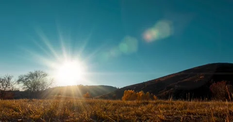 Mountain meadow time-lapse at the summer or autumn sunset time. Wild nature and Stock Footage 290443322