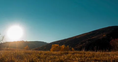 Mountain meadow time-lapse at the summer or autumn sunset time. Wild nature and Stock Footage 291785942