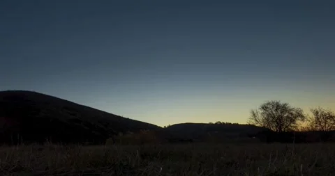 Mountain meadow time-lapse at the summer or autumn sunrise time. Wild nature and Stock Footage 310718639