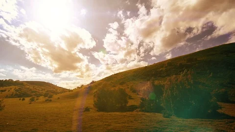 Mountain meadow timelapse at the summer. Clouds, trees, green grass and sun rays Stock Footage 129263369