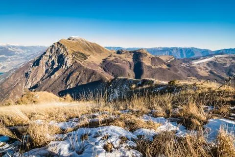 Mountain meadows still partially covered with snow. Stock Photos
