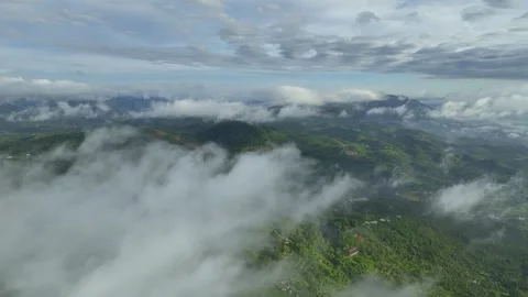 Mountain Mist Marvel: Aerial Expedition to 4K Cloud-Enveloped Summits Stock Footage 244473793