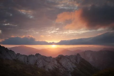 Mountain in the mist at sunset Stock Photos