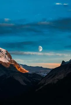 Mountain with a moon in the sky Stock Photos