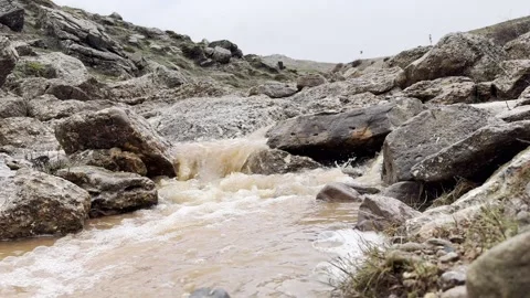 Mountain muddy stream Stock Footage 306553616
