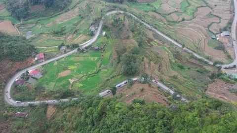 Mountain Pass Cuts Through Farm Land in Northern Vietnam Aerial Drone Video Video stock 125538055