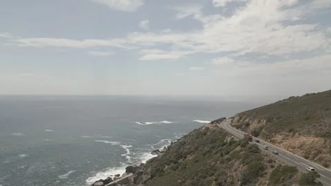 Mountain pass next to a cliff with waves rolling through Stock Footage 318064604